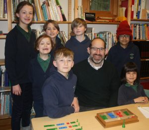 Principal's Blog - image of the principal sat with a group of children of mixed ages